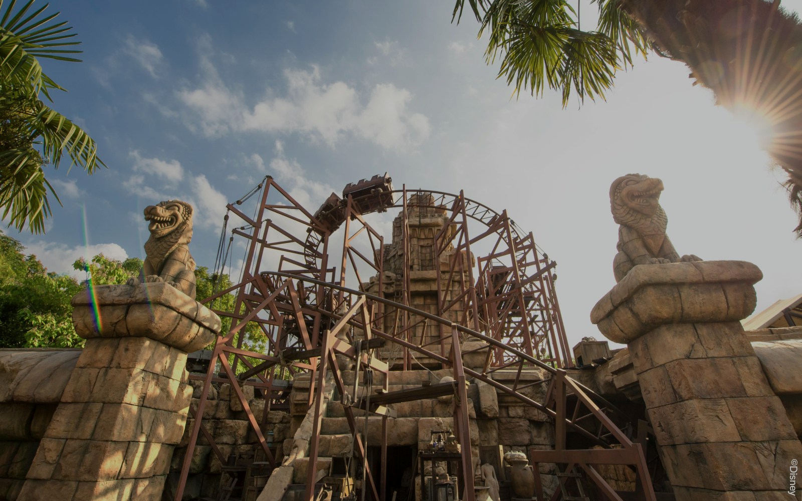 Indiana Jones roller coaster at Disneyland Paris with temple ruins in the background.