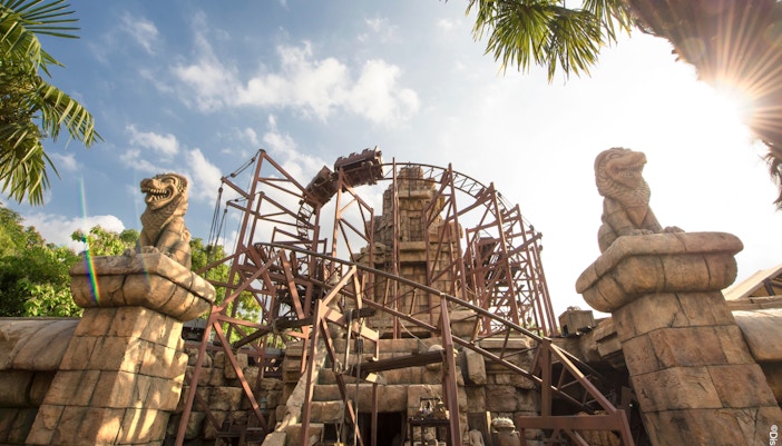 Indiana Jones roller coaster at Disneyland Paris with temple ruins in the background.