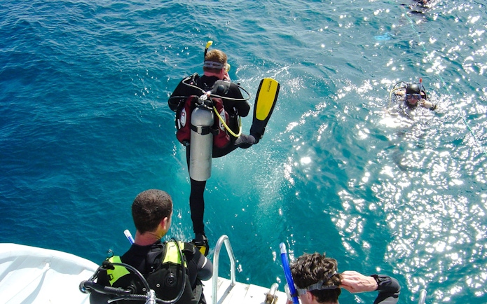Scuba divers jumping into the Red Sea for a dive, Hurghada.