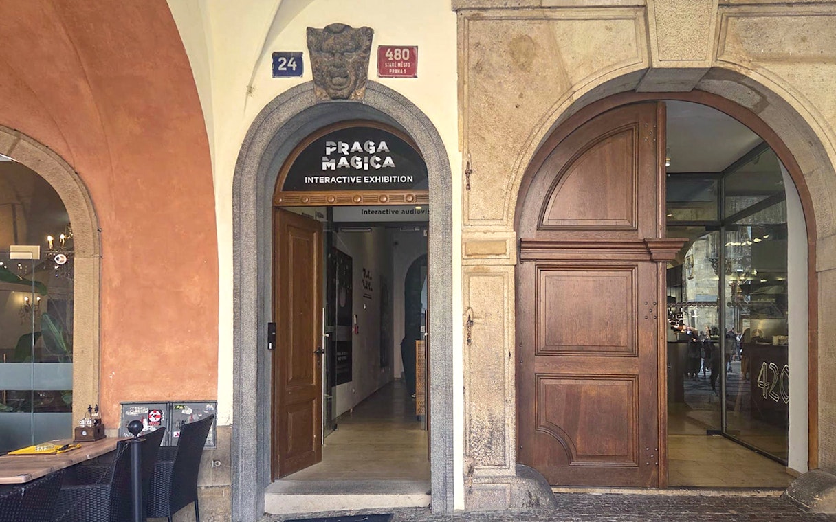 Entrance to Praga Magica Interactive Exhibition in Prague, featuring arched doorway.