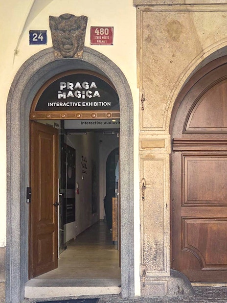 Entrance to Praga Magica Interactive Exhibition in Prague, featuring arched doorway.
