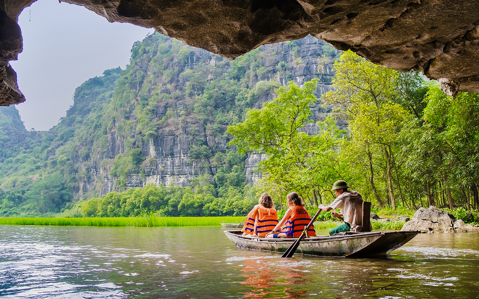 Boating through limestone caves and lush greenery in Tam Coc, Vietnam.