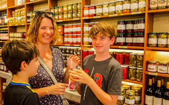 Family enjoying pickles at a shop during an Istanbul food tour.