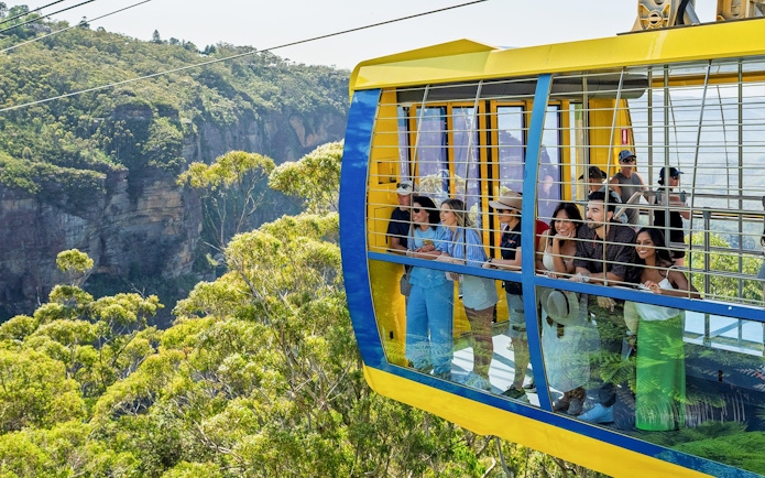 Tourists enjoying a cable car ride over the Blue Mountains, Australia.