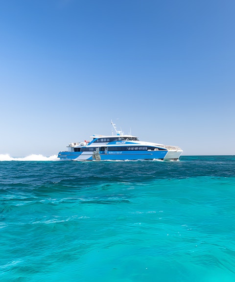 Ferry cruising on turquoise waters towards Rottnest Island from Perth.