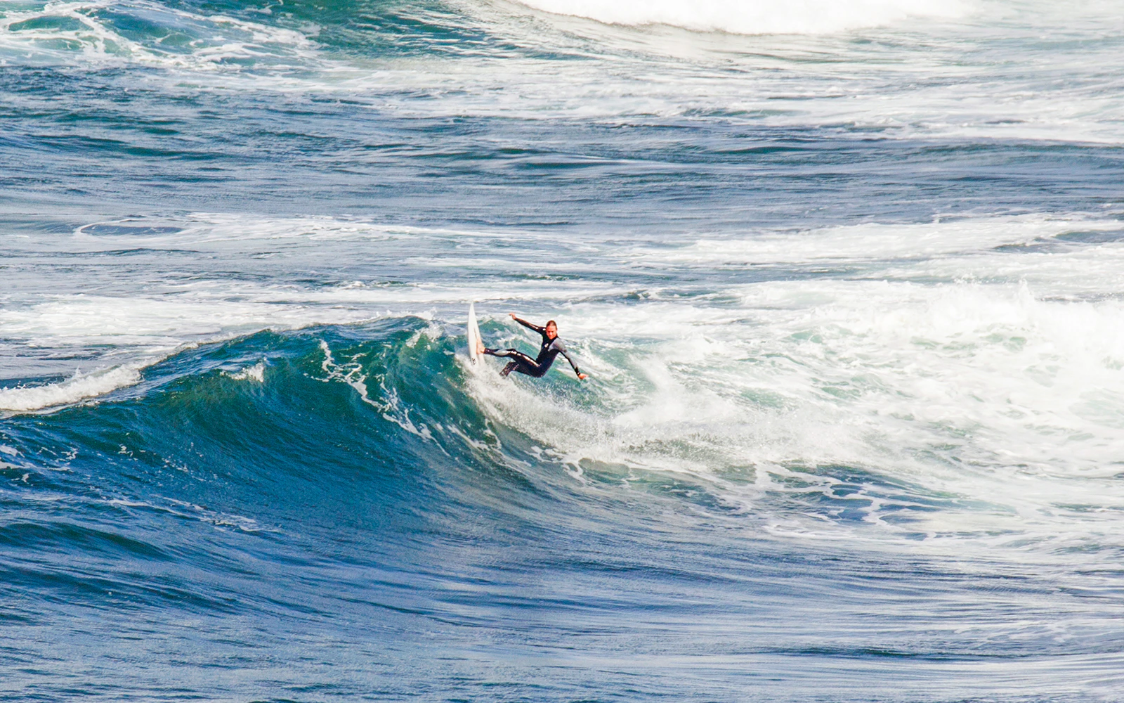 Surfer riding waves