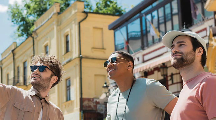 Tourists exploring near Danube Tower, Vienna, with historic buildings in the background.
