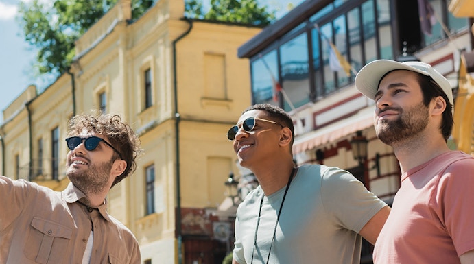 Tourists exploring near Danube Tower, Vienna, with historic buildings in the background.