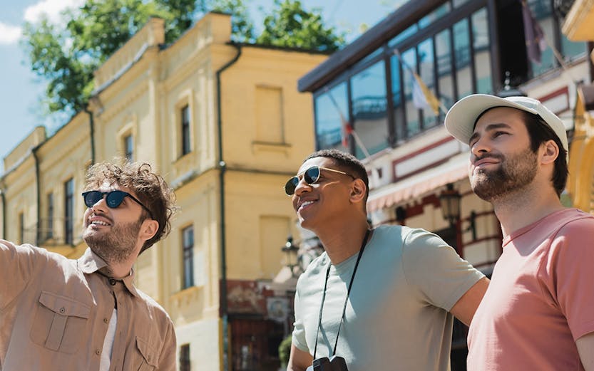 Tourists exploring near Danube Tower, Vienna, with historic buildings in the background.