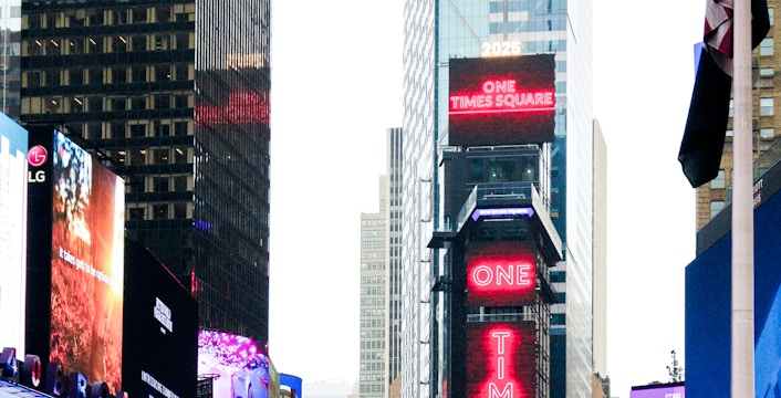 One Times Square building with bright neon signs in New York City.