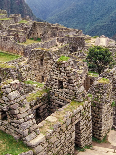 Residential section ruins of Machu Picchu, Peru, with stone structures and terraces.