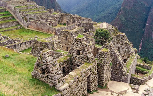 Residential section ruins of Machu Picchu, Peru, with stone structures and terraces.