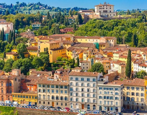 Florence hop-on hop-off bus near Oltrarno district with view of historic architecture.