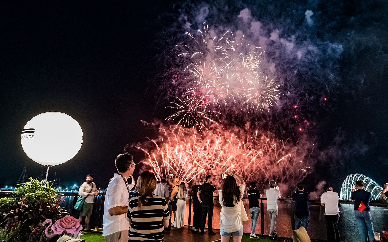 People enjoying a view of fireworks from Twenty3, Singapore F1