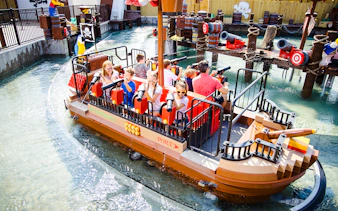 Guests enjoying a pirate-themed boat ride at Legoland New York.