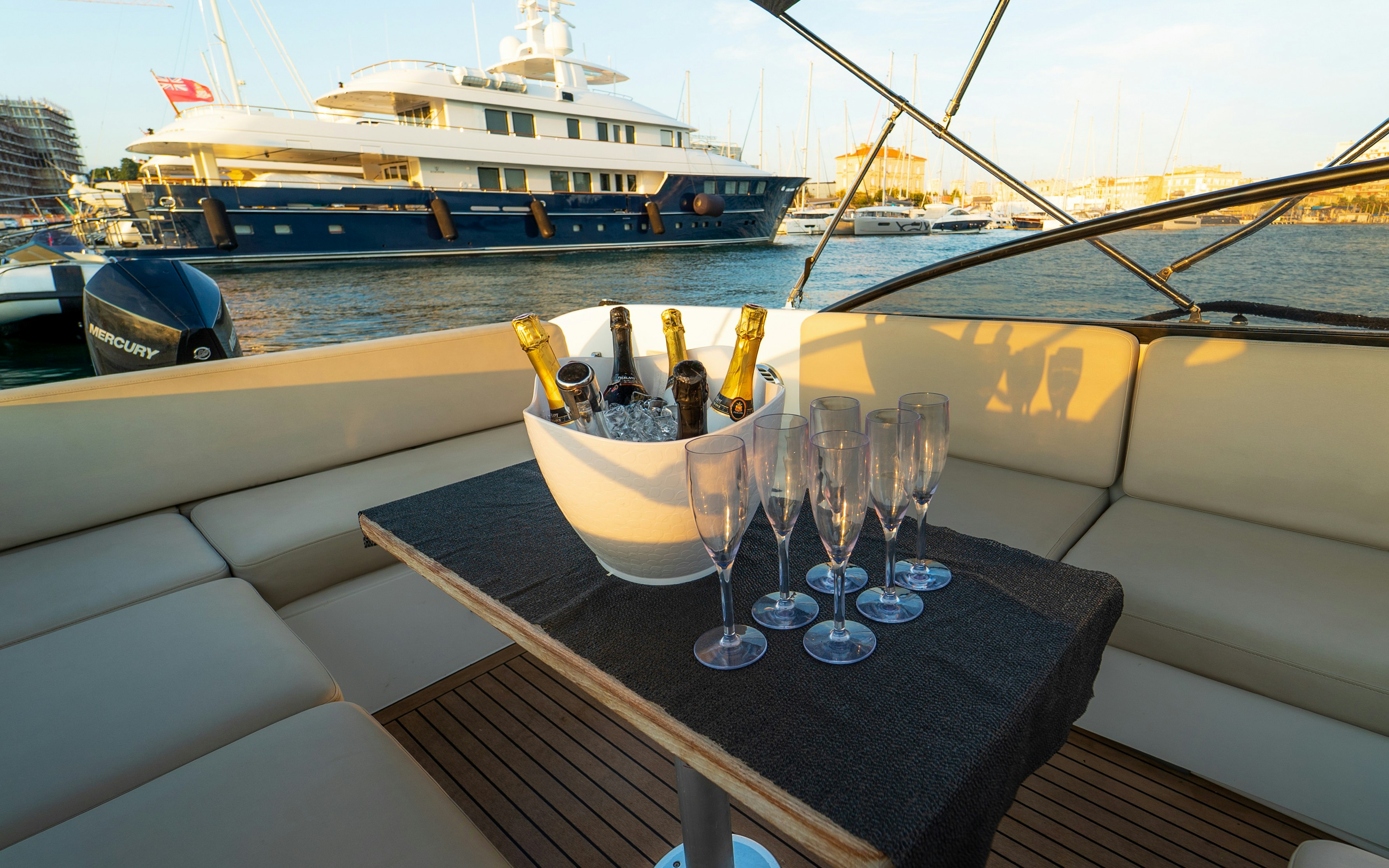 Sunset cruise in Zadar with sparkling wine and glasses on a yacht deck.
