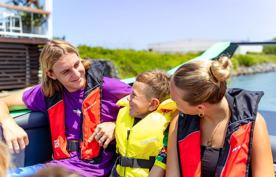 Family enjoying Arro Jet Boat tour on Gold Coast waters.