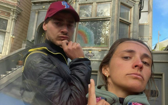 People posing in front of a colorful house in Haight Ashbury, San Francisco.