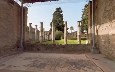 Ancient columns and garden at the archaeological site of Pompeii, Italy.