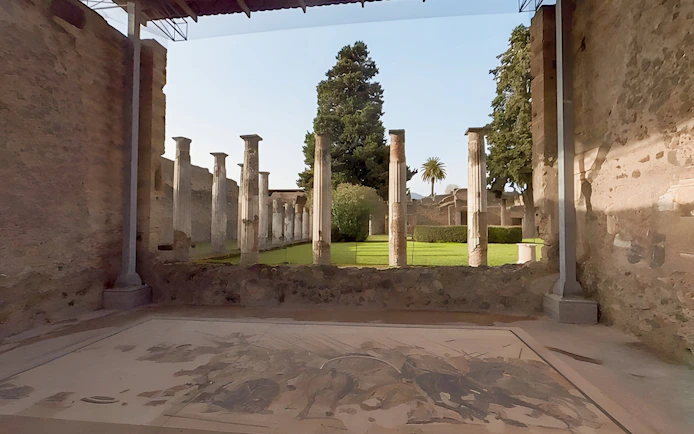 Ancient columns and garden at the archaeological site of Pompeii, Italy.