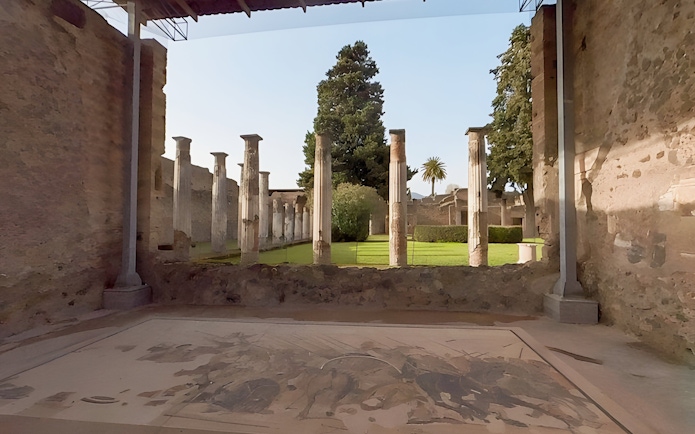 Ancient columns and garden at the archaeological site of Pompeii, Italy.