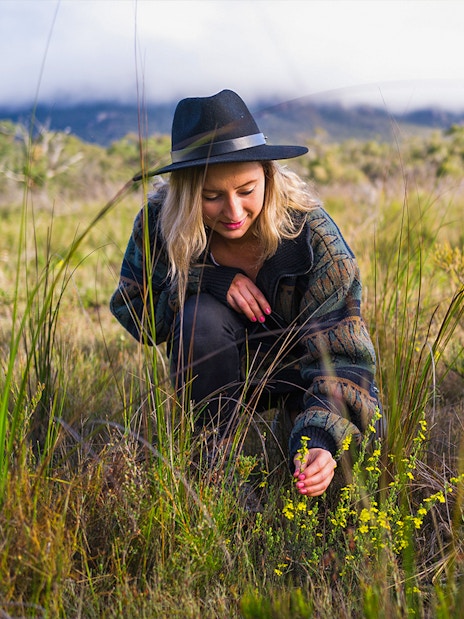 Person exploring native plants in Grampians wilderness on a guided tour from Melbourne.