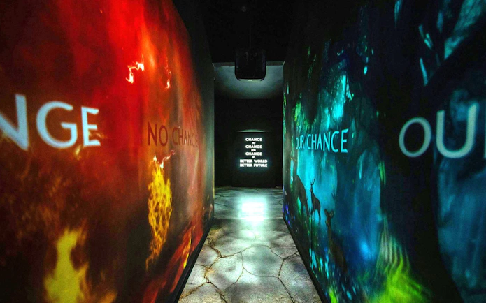 Hallway with illuminated messages about change and a better future.
