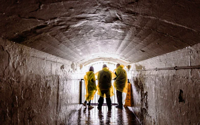 Visitors in yellow ponchos in a tunnel at Journey Behind the Falls, Niagara Falls.