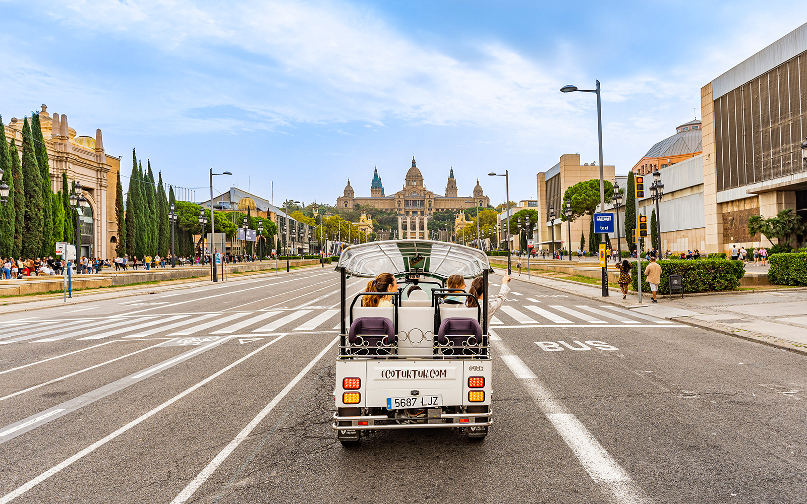Tuk tuk driving towards the National Palace in Barcelona.