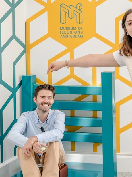 Guests enjoying an optical illusion at the Museum of Illusions Amsterdam.