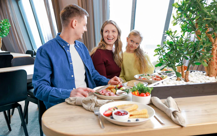Family enjoying buffet meal on ferry from Tallinn to Helsinki.