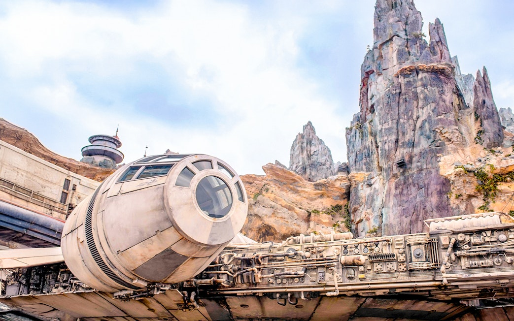 Spaceship attraction at Universal Studios Resort, Orlando, Florida with rocky landscape.