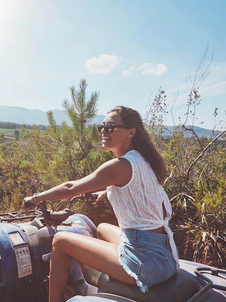 Quad biking on a dirt trail with scenic mountain views in Antalya.