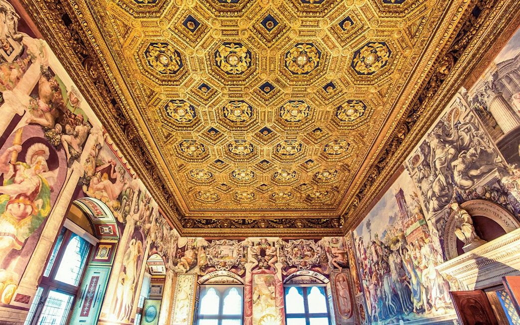 Palazzo Vecchio ornate ceiling and frescoes during skip-the-line guided tour in Florence, Italy.