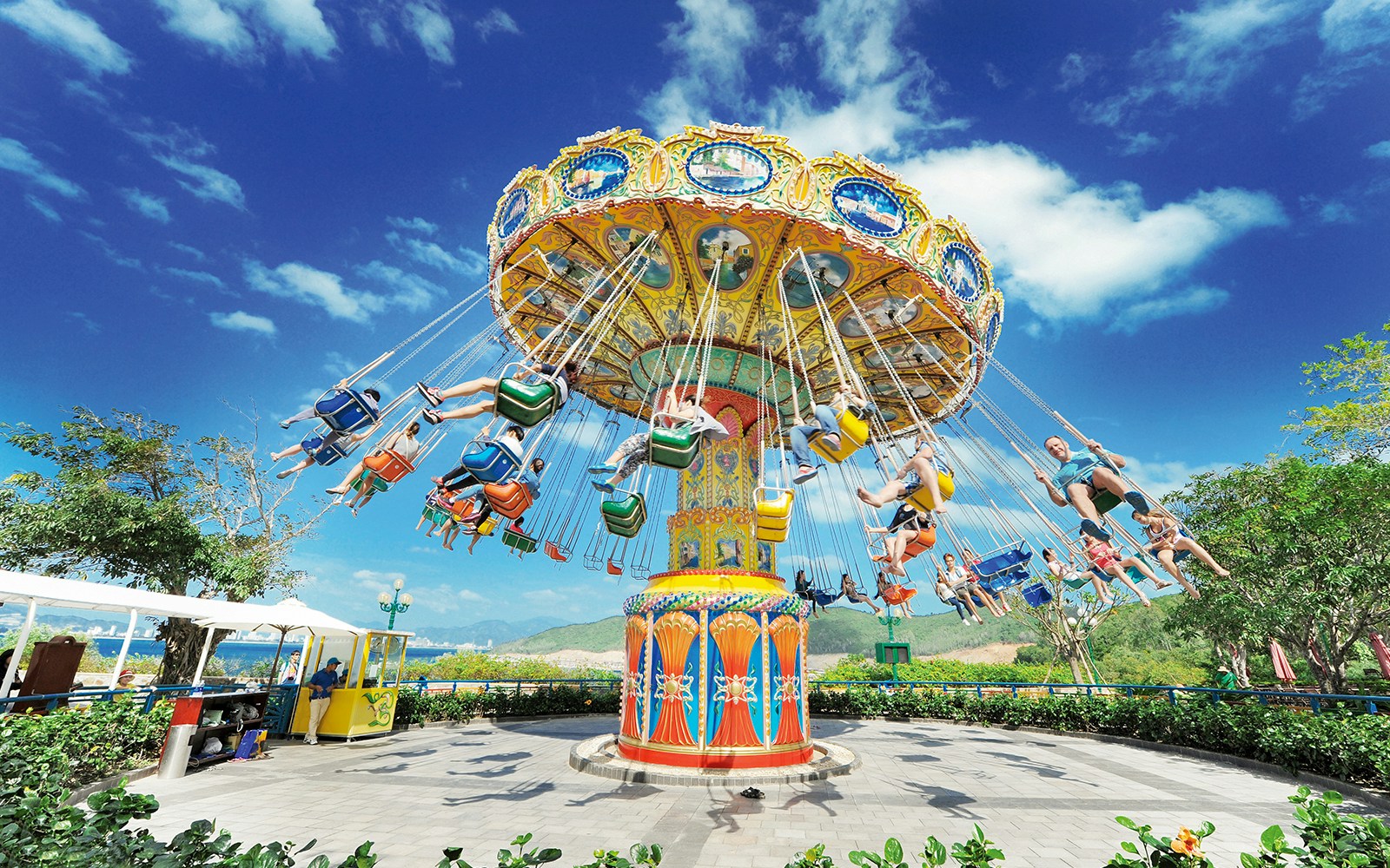 Flying chair ride at VinWonders Nha Trang Theme Park with people enjoying the attraction.