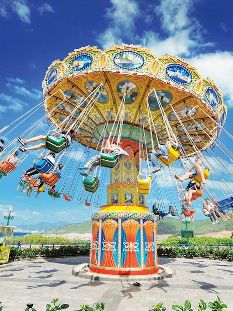 Flying chair ride at VinWonders Nha Trang Theme Park with people enjoying the attraction.