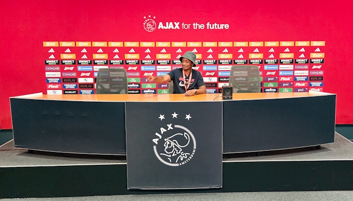 Person sitting at the press conference desk in Johan Cruijff ArenA, Amsterdam.