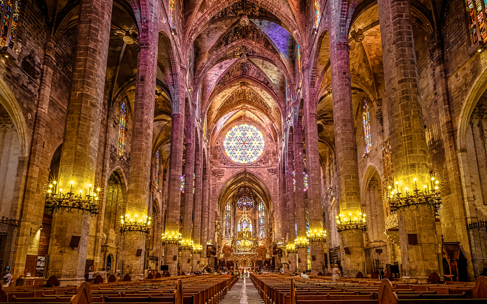 Interior view of Cathedral of Santa Maria of Palma with stained glass windows and vaulted ceilings.