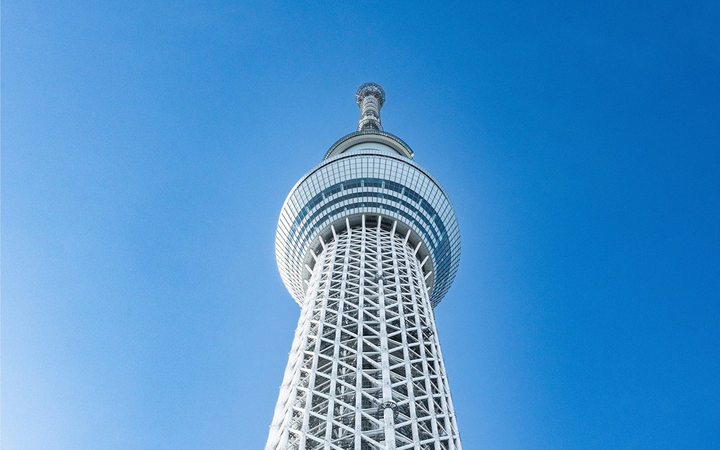 Tokyo Skytree tower against a clear blue sky.