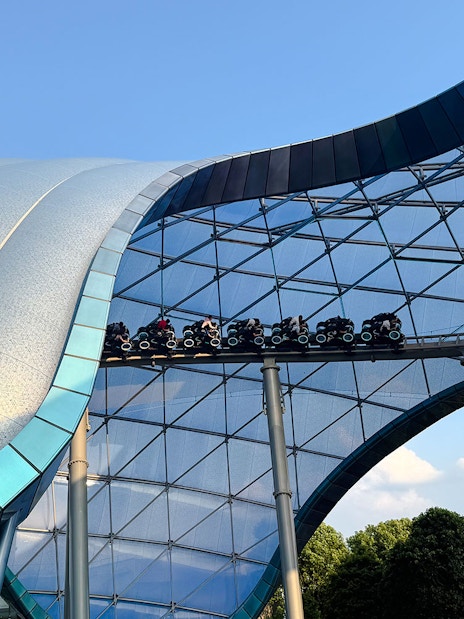 TRON Lightcycle Power Run roller coaster under futuristic canopy.