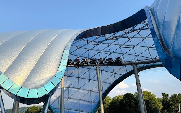TRON Lightcycle Power Run roller coaster under futuristic canopy.