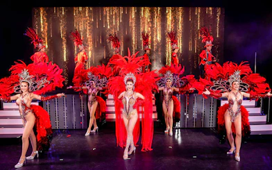 Performers in vibrant costumes on stage at Simon Cabaret Show, Phuket.