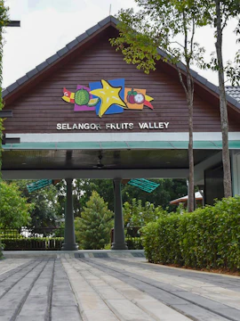 Selangor Fruit Valley entrance with colorful fruit signage and lush greenery.