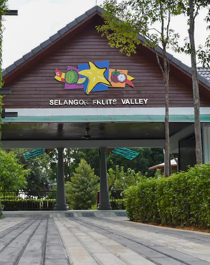 Selangor Fruit Valley entrance with colorful fruit signage and lush greenery.