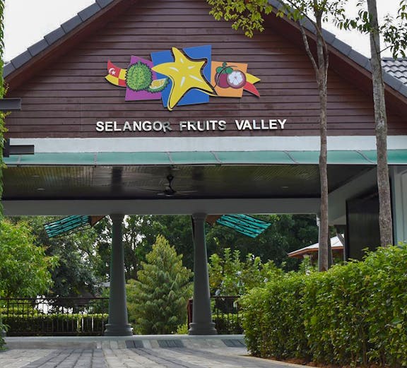 Selangor Fruit Valley entrance with colorful fruit signage and lush greenery.
