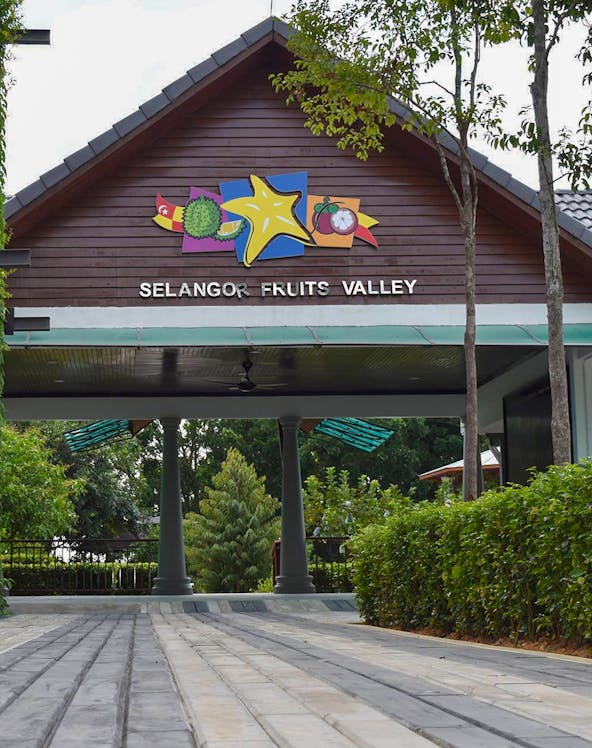 Selangor Fruit Valley entrance with colorful fruit signage and lush greenery.