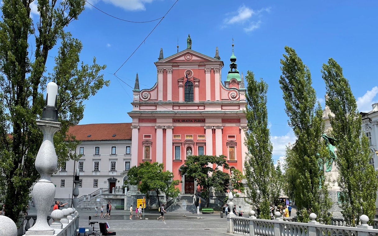 Franciscan Church in Ljubljana, Slovenia, seen from the Triple Bridge on a sunny day.