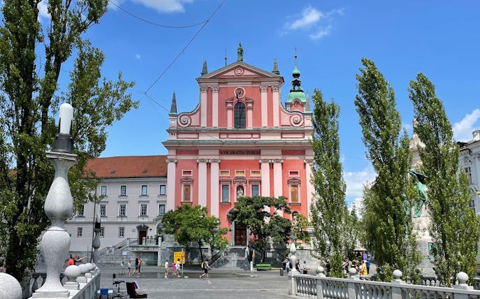 Franciscan Church in Ljubljana, Slovenia, seen from the Triple Bridge on a sunny day.