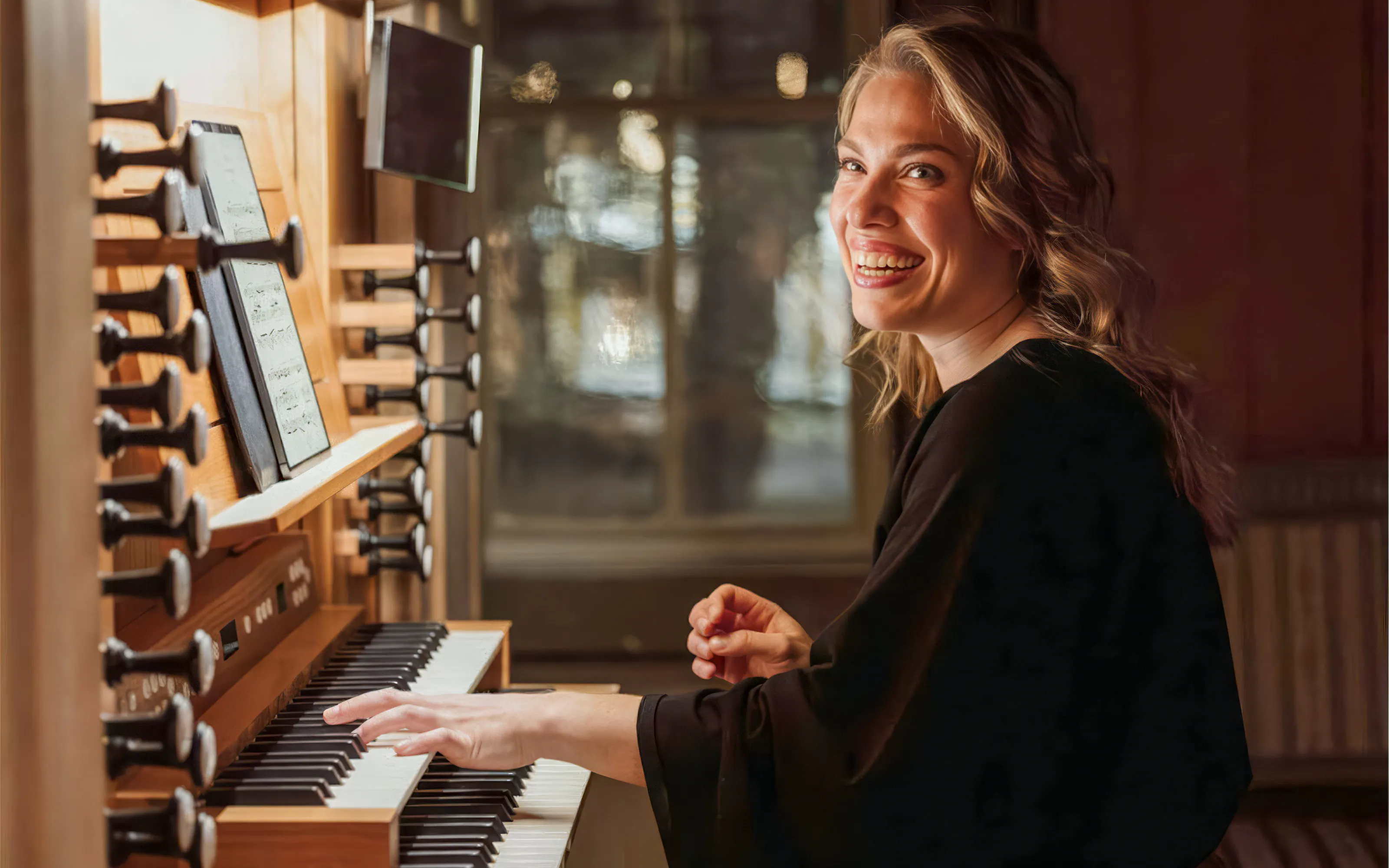 Performer playing organ at midnight concert in Tromso Cathedral.