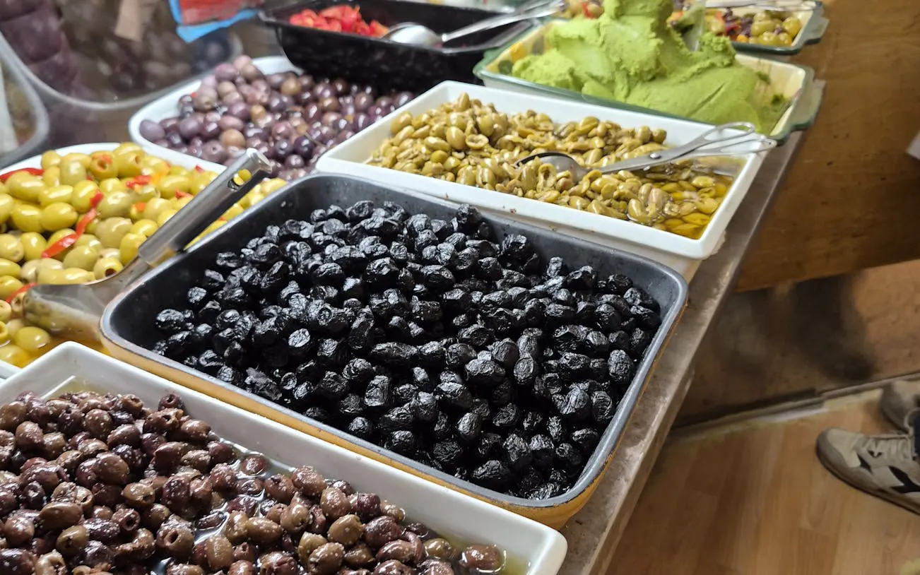 Assorted olives and spreads at Padova market during food tour.
